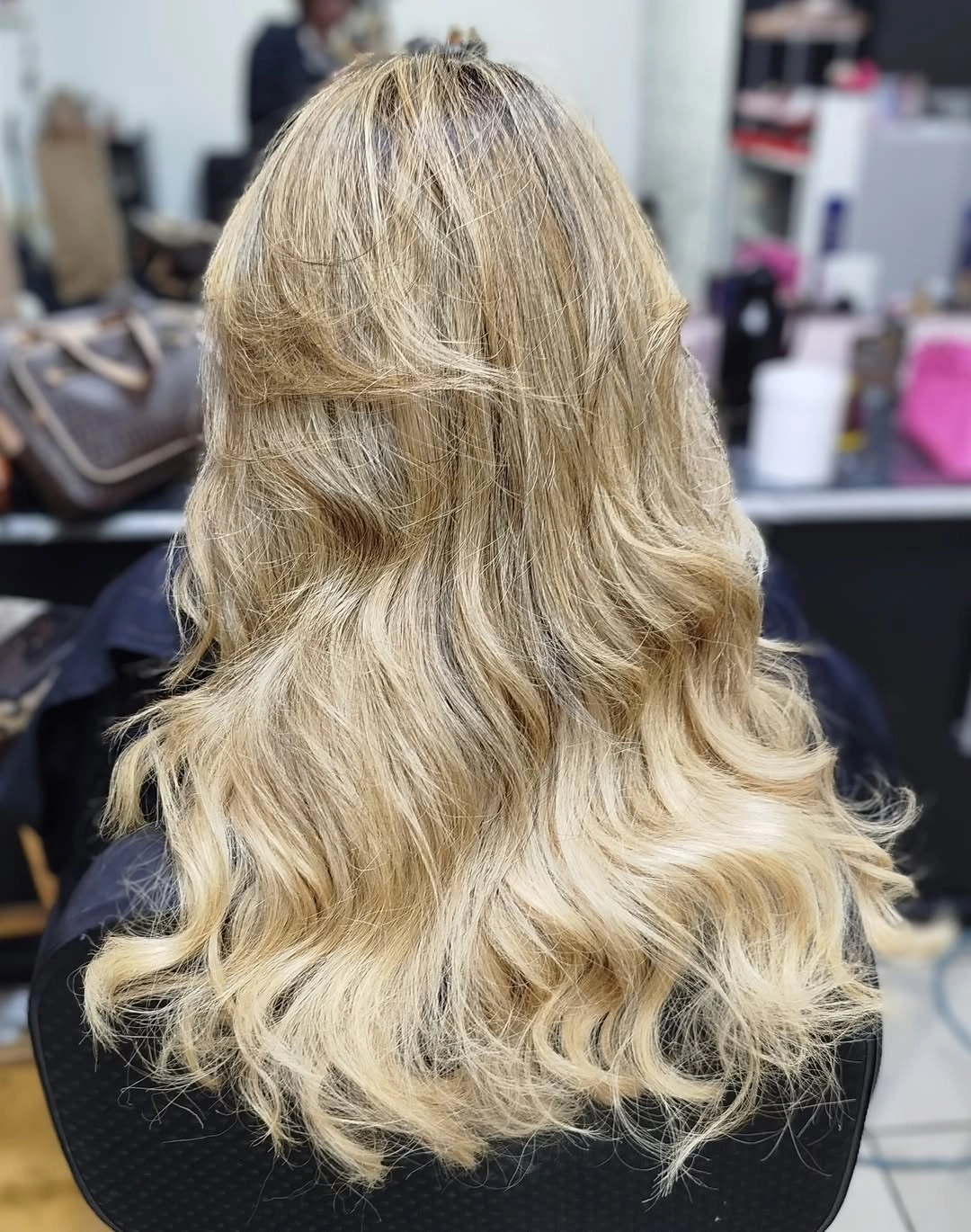 Medium shaggy blonde waves with darker root area
