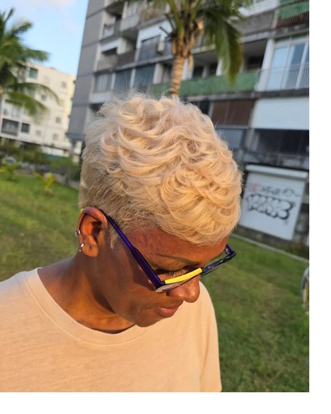 Very short warm platinum curls with darker sides