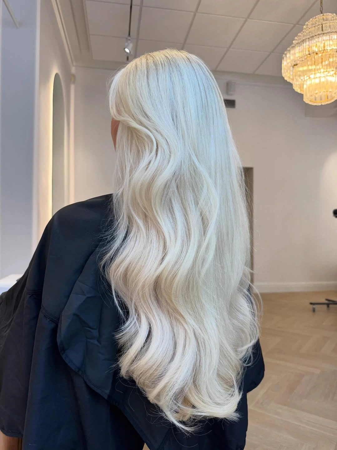 Long icy white blonde waves with curled ends