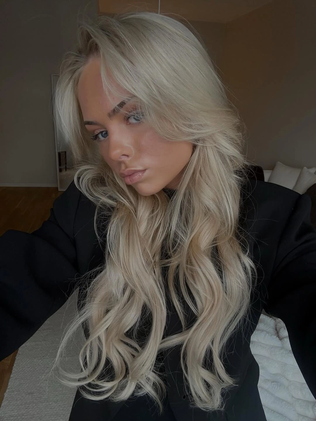 Long side-swept platinum blonde hair with waves