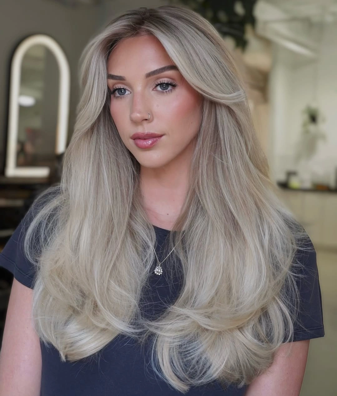 Long cool beige blonde hair with curtain layers