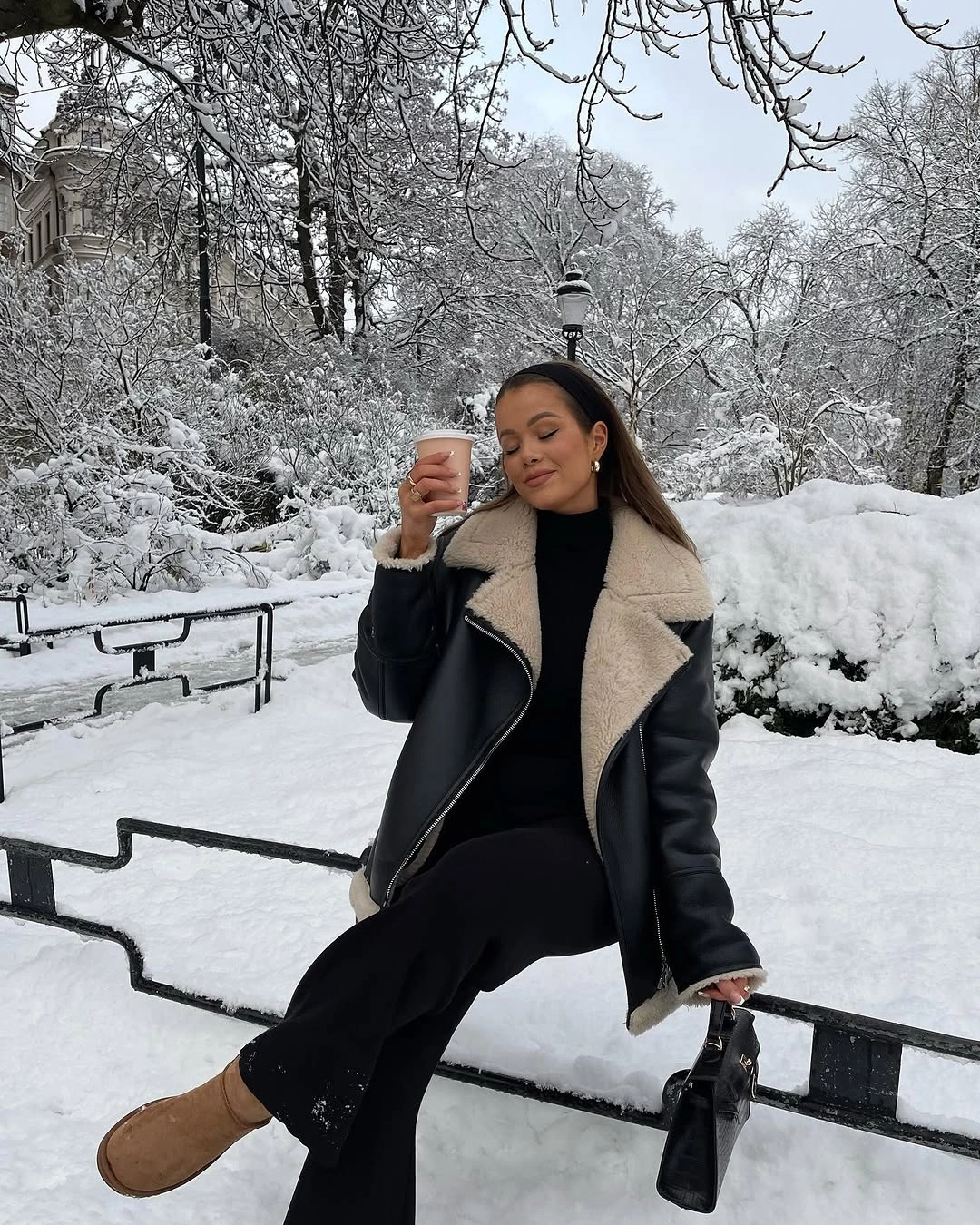Black jacket with cream collar, wide trousers and tan boots