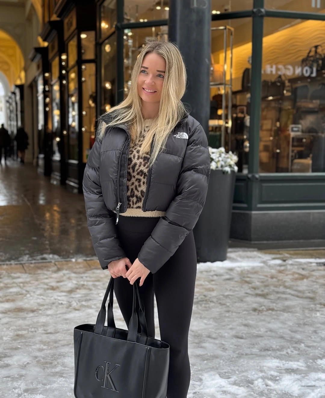 Dark puffer with leopard panel, black leggings and tote