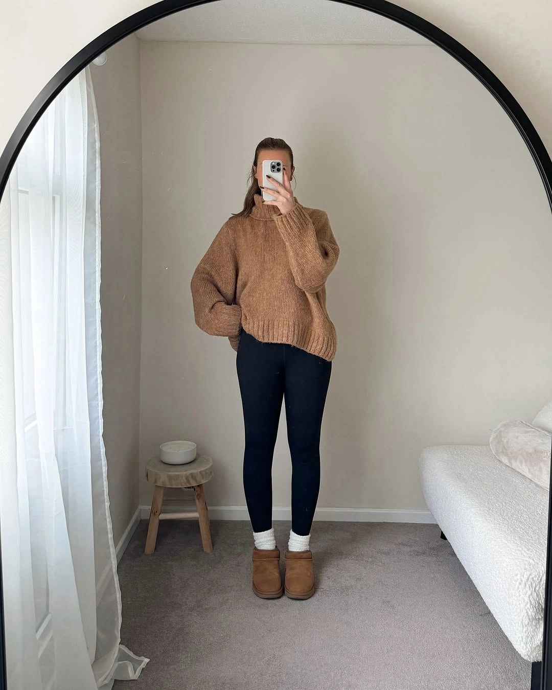 Warm brown turtleneck with black leggings and tan boots