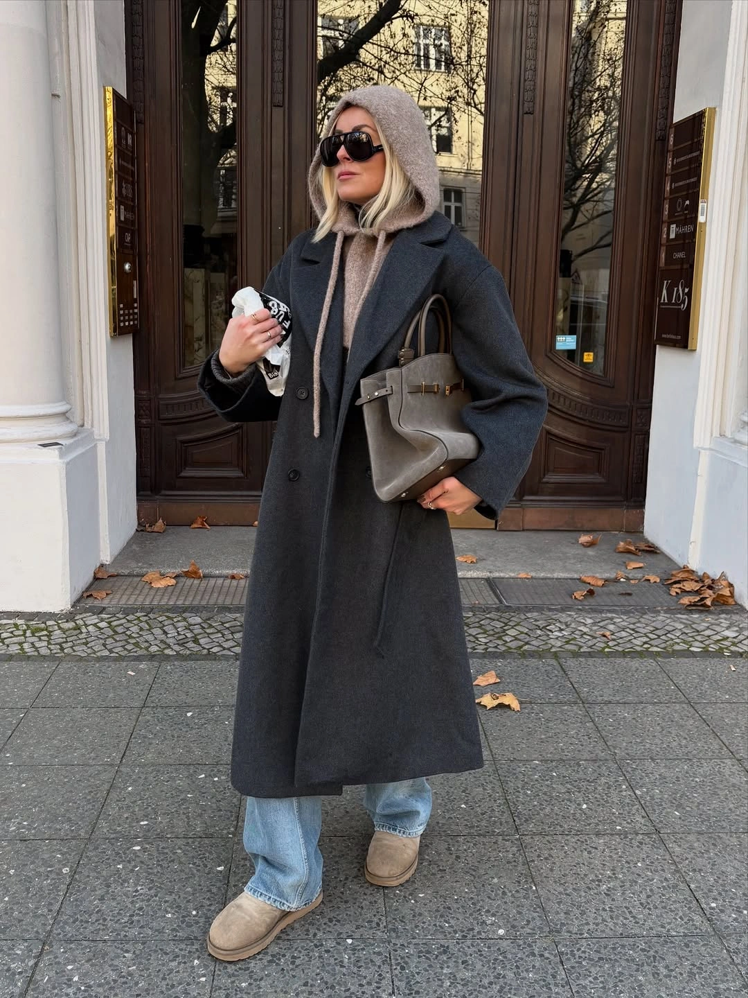 Long charcoal coat with hooded layer, jeans and beige boots