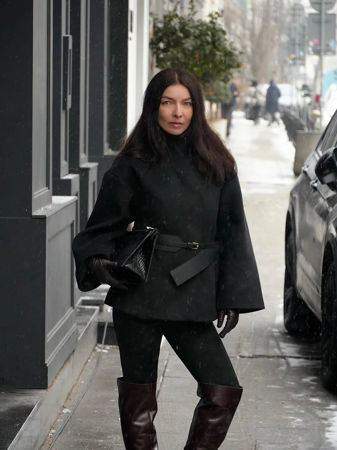 Black belted cape outfit with burgundy knee-high boots