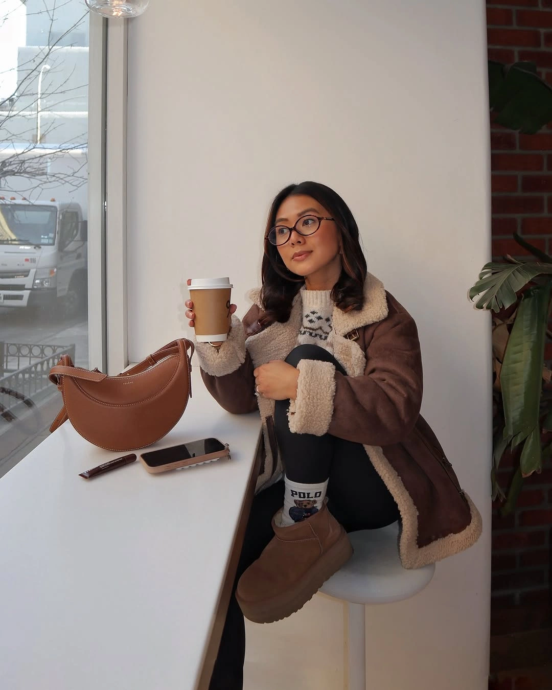 Brown jacket with cream trim and tan ankle boots