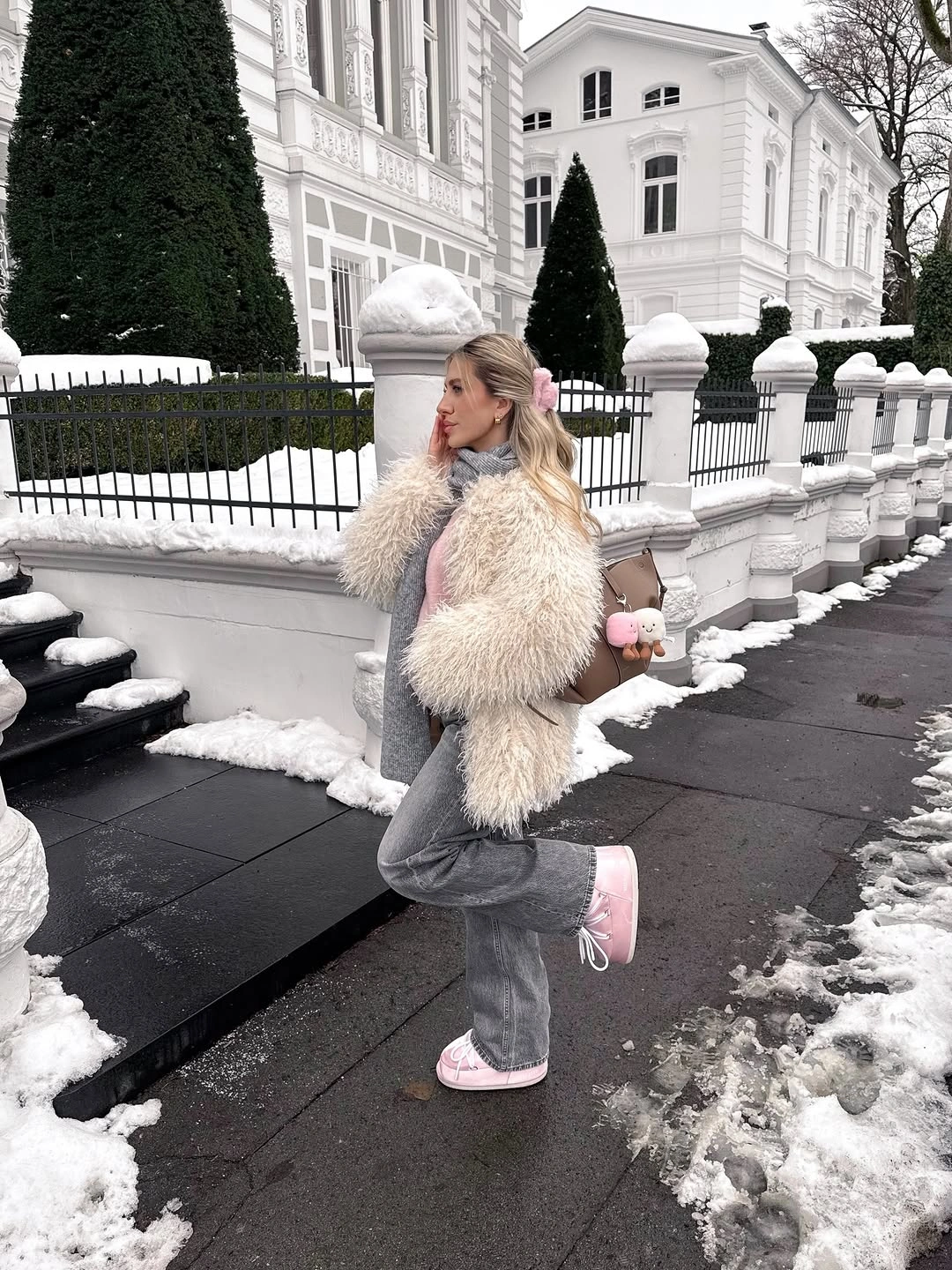 Cream shaggy cropped jacket with gray trousers and pink sneakers