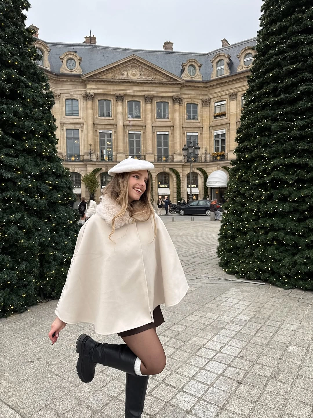 Pale ivory cape with white hat and black boots