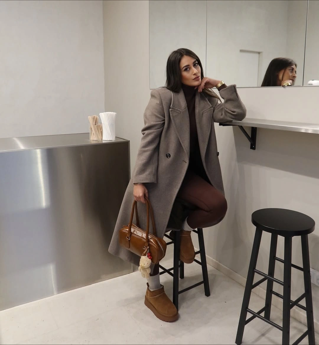 Gray-brown blazer with tan boots and brown handbag