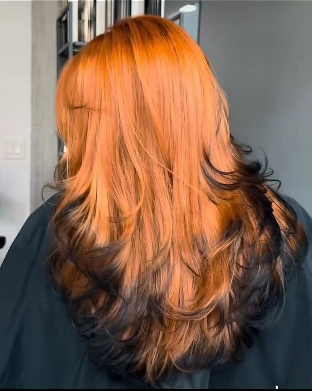 Long layered copper orange hair with darker brown underlayers