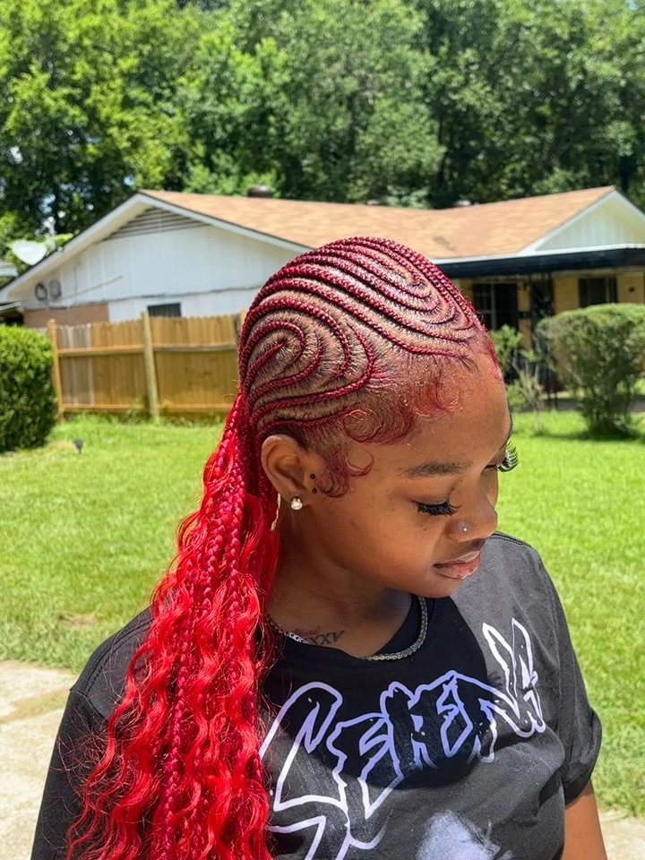 Red and burgundy braids with intricate patterned cornrows