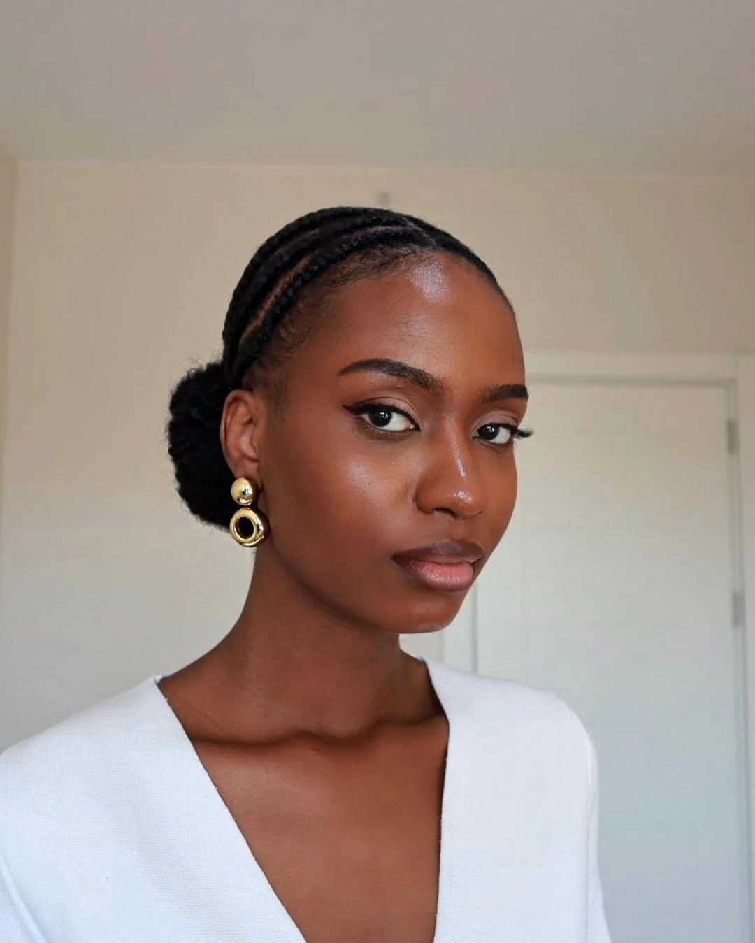 Dark braided rows gathered into a polished low bun