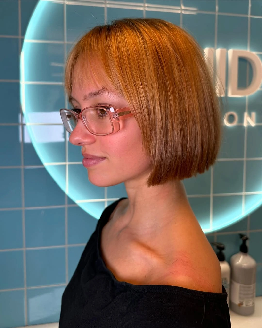 Chin length copper orange bob with straight fringe
