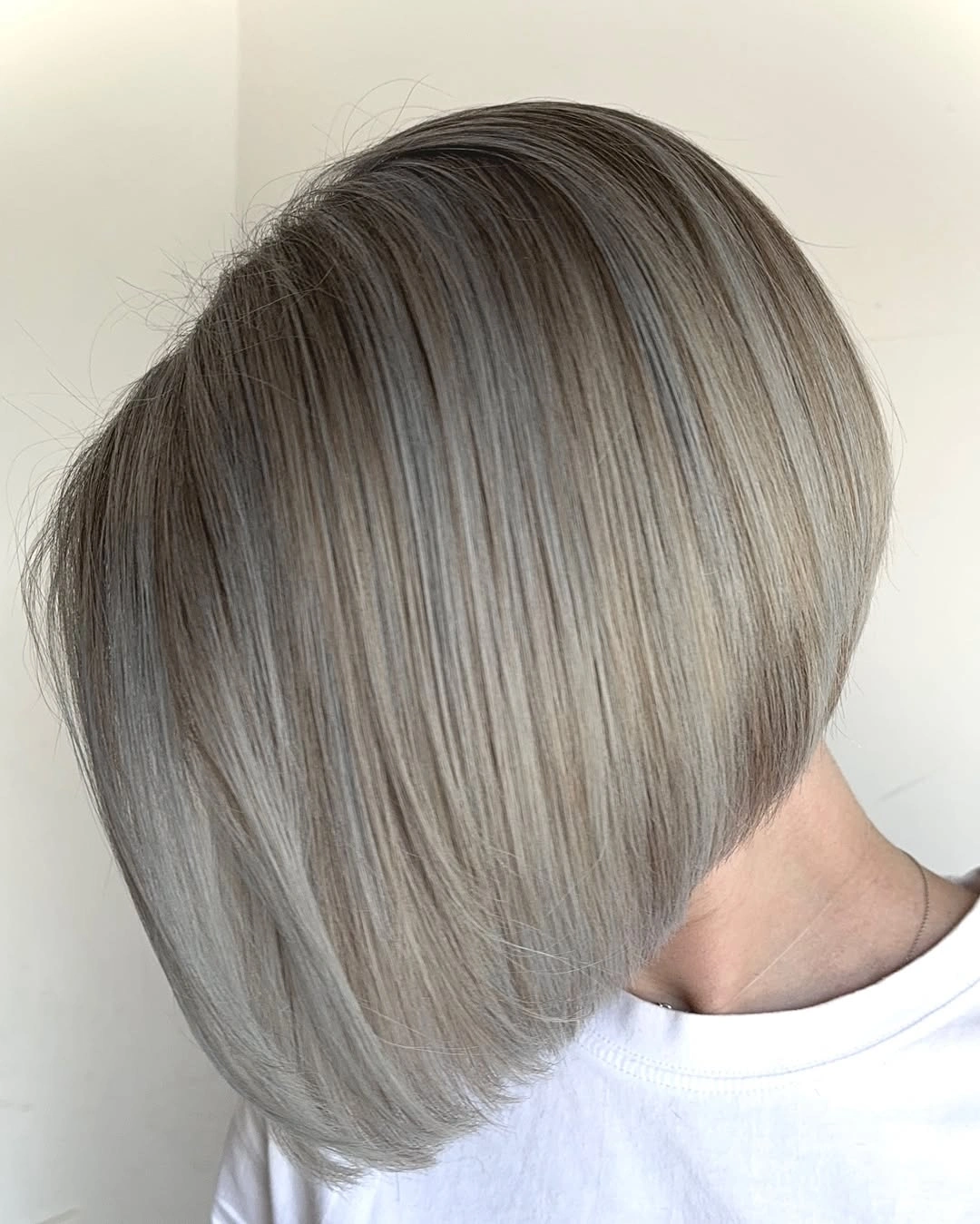 Short angled ash beige bob with darker nape
