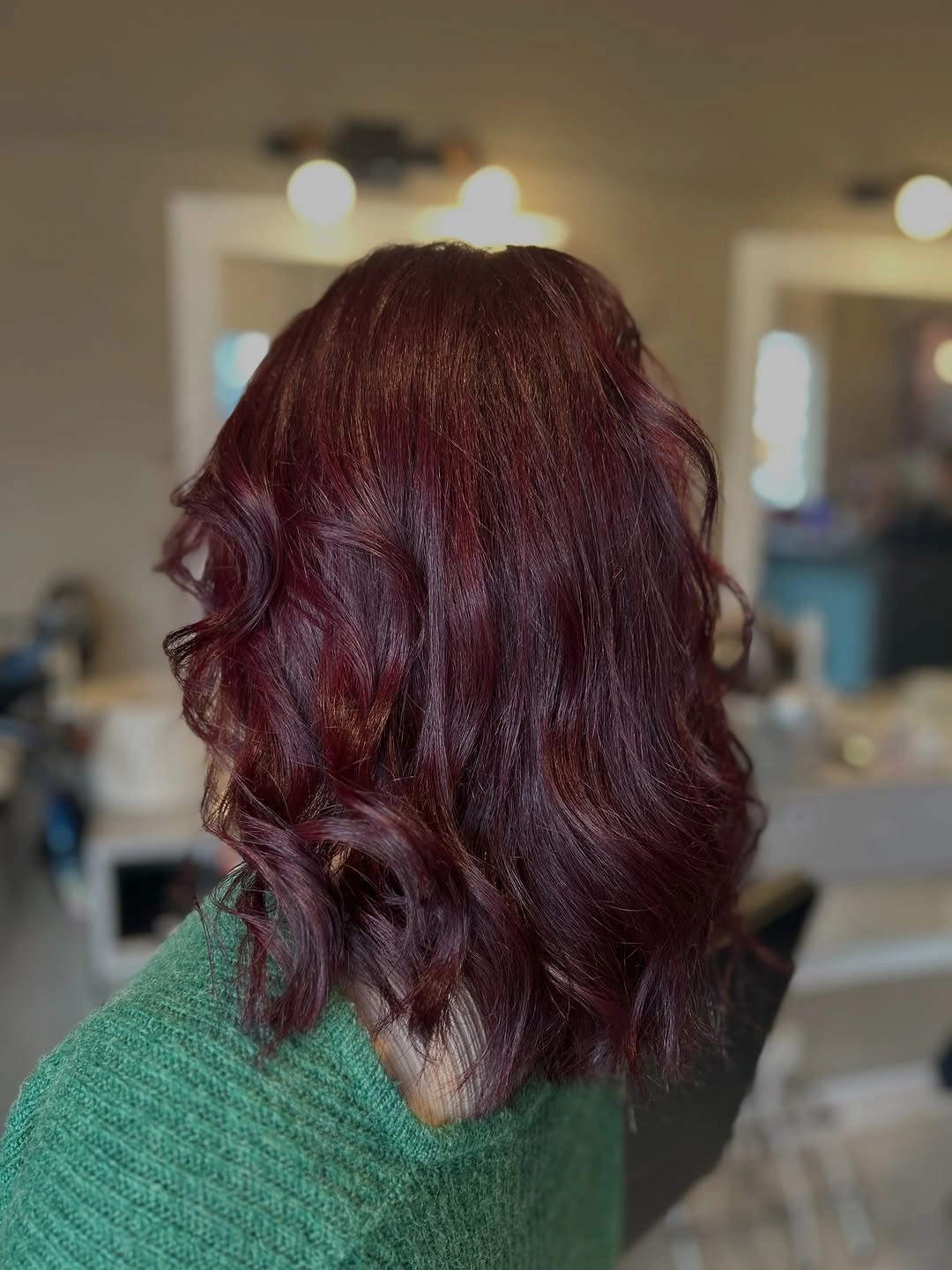 Shoulder length wine burgundy hair with rounded curls