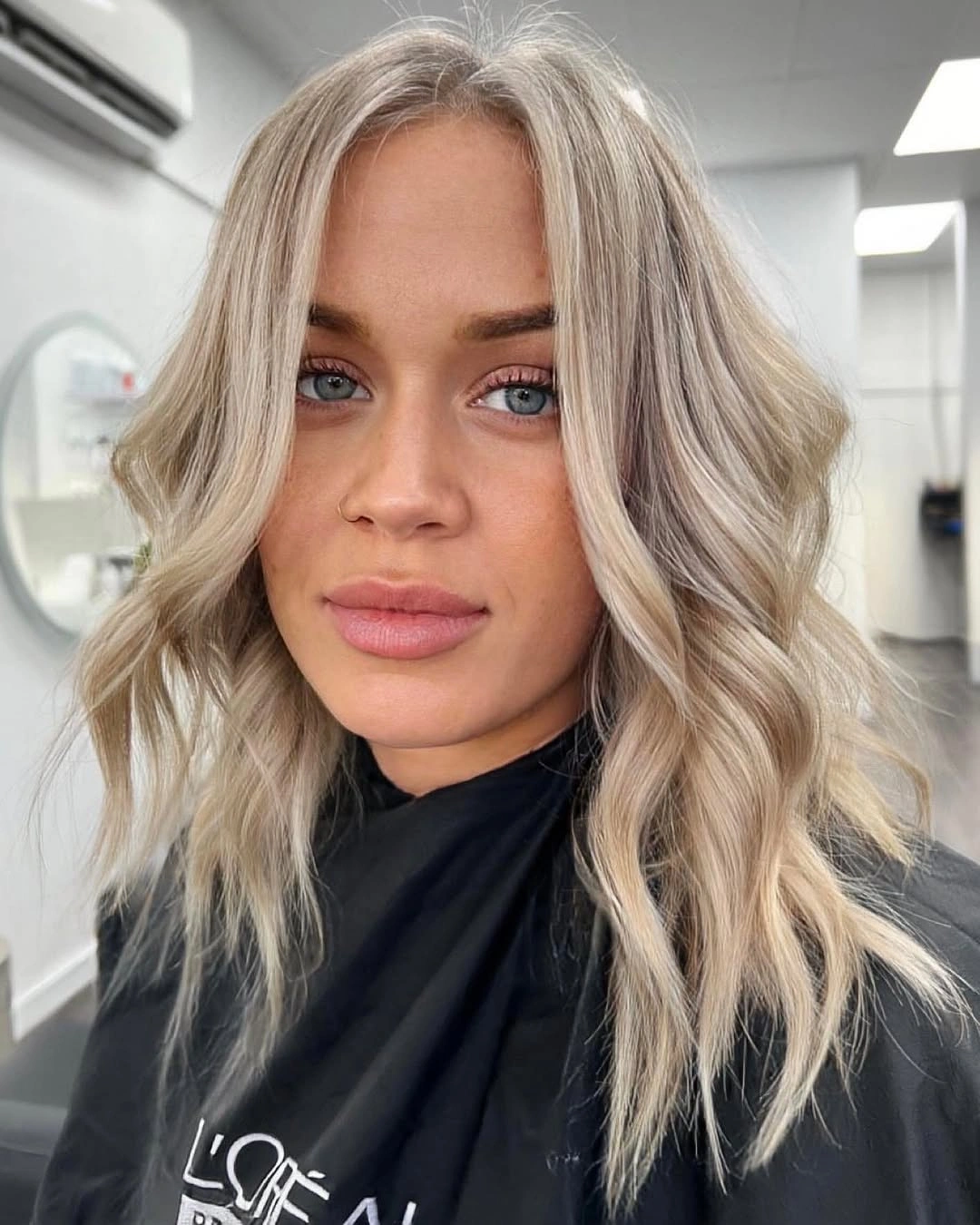 Shoulder length pale blonde waves with darker root depth