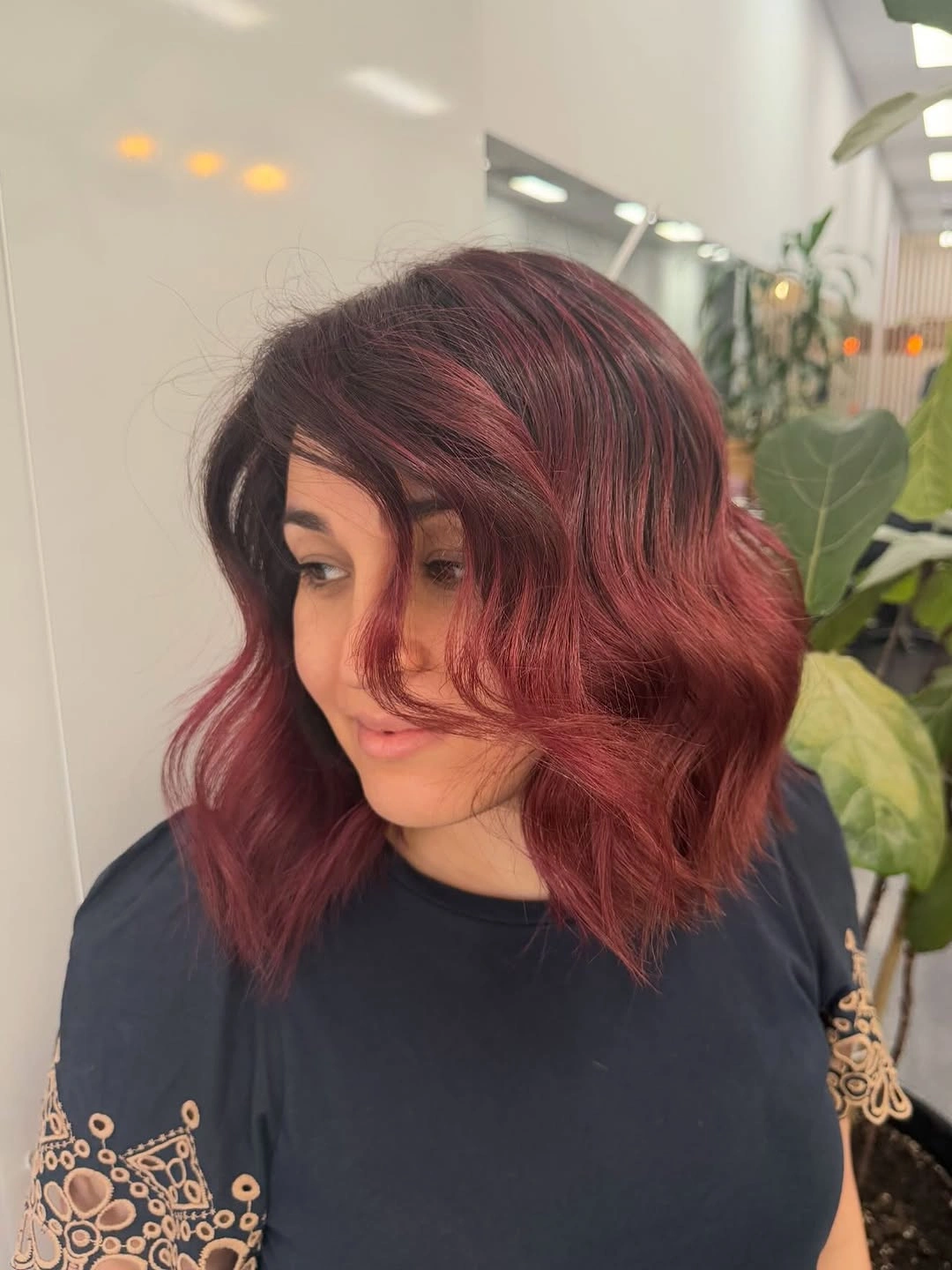 Shoulder length burgundy red hair with side swept front