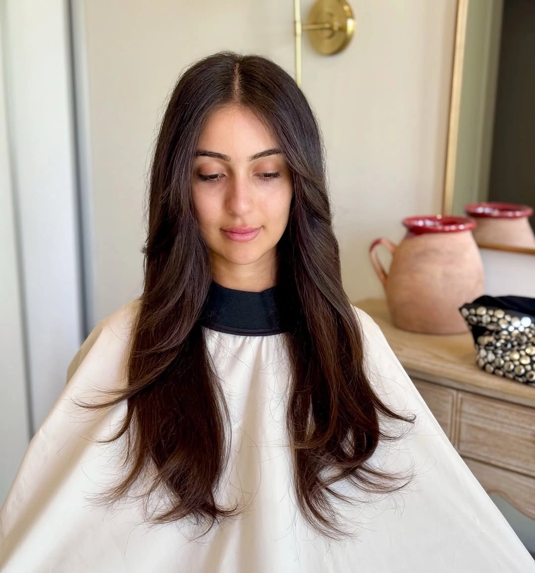 Long brown layered haircut with face framing pieces