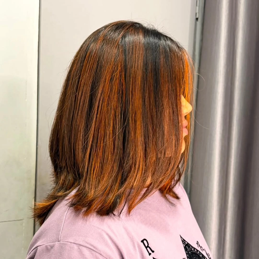 Textured copper mid length haircut shown from the side