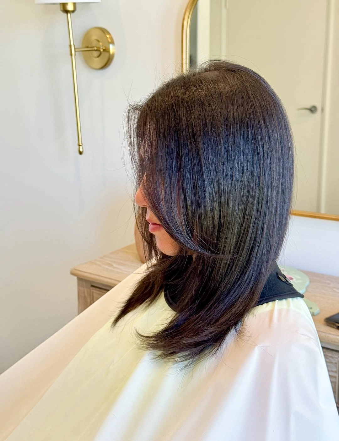 Dark shoulder length bob with a cool blue gray sheen