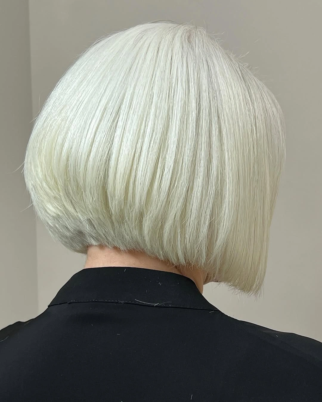 Pale blonde rounded bob haircut shown from the back