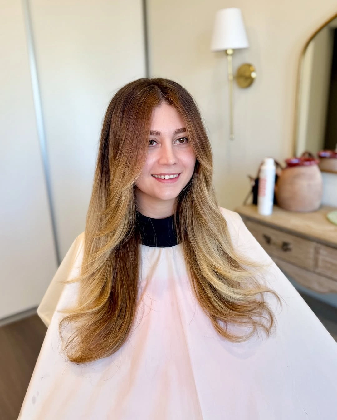 Long caramel haircut with soft waves and face framing