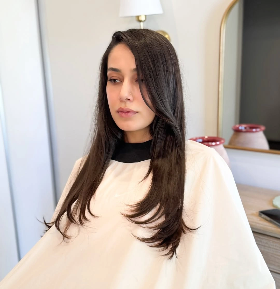 Long dark layered haircut with a swept front