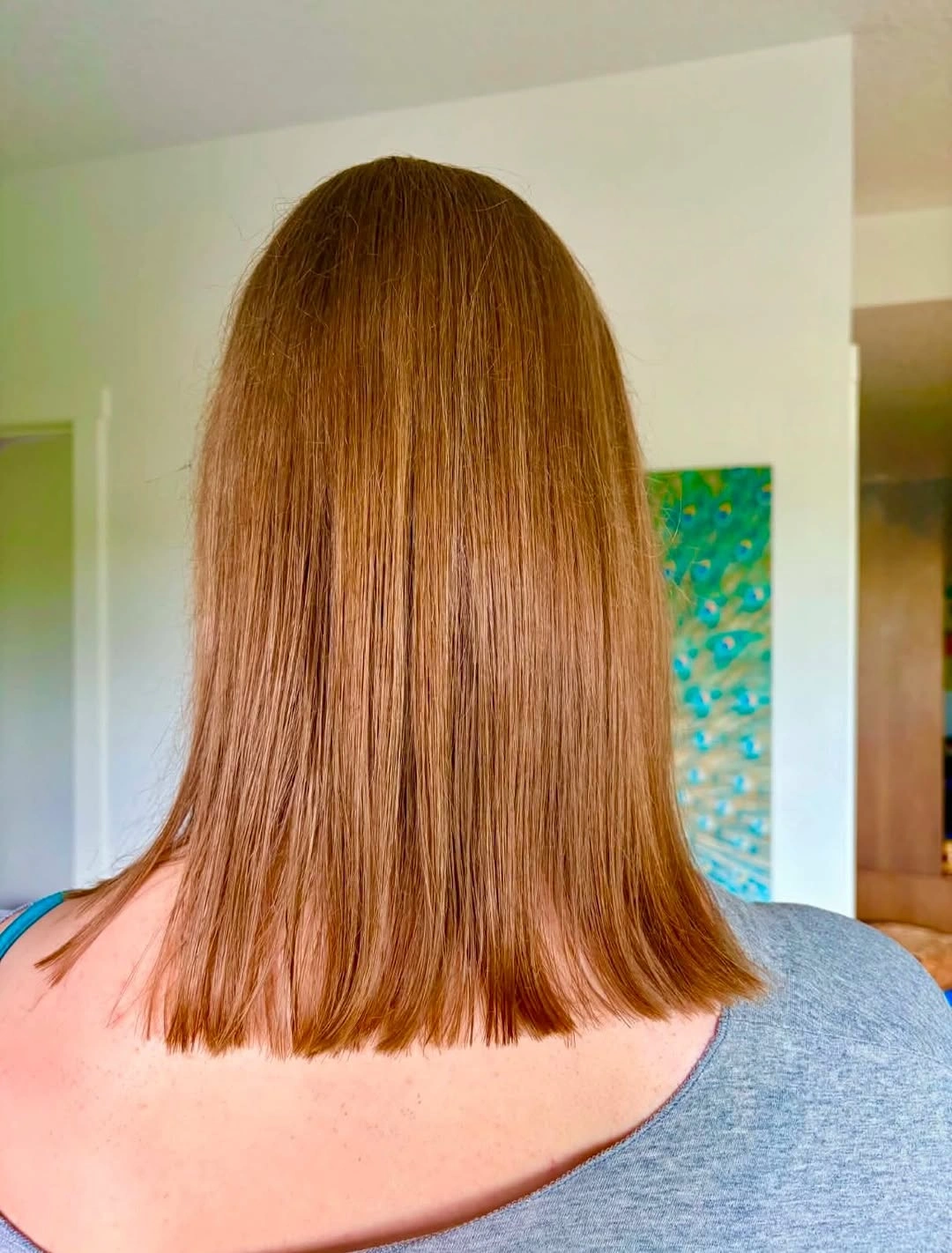 Straight copper shoulder length haircut with a clean edge