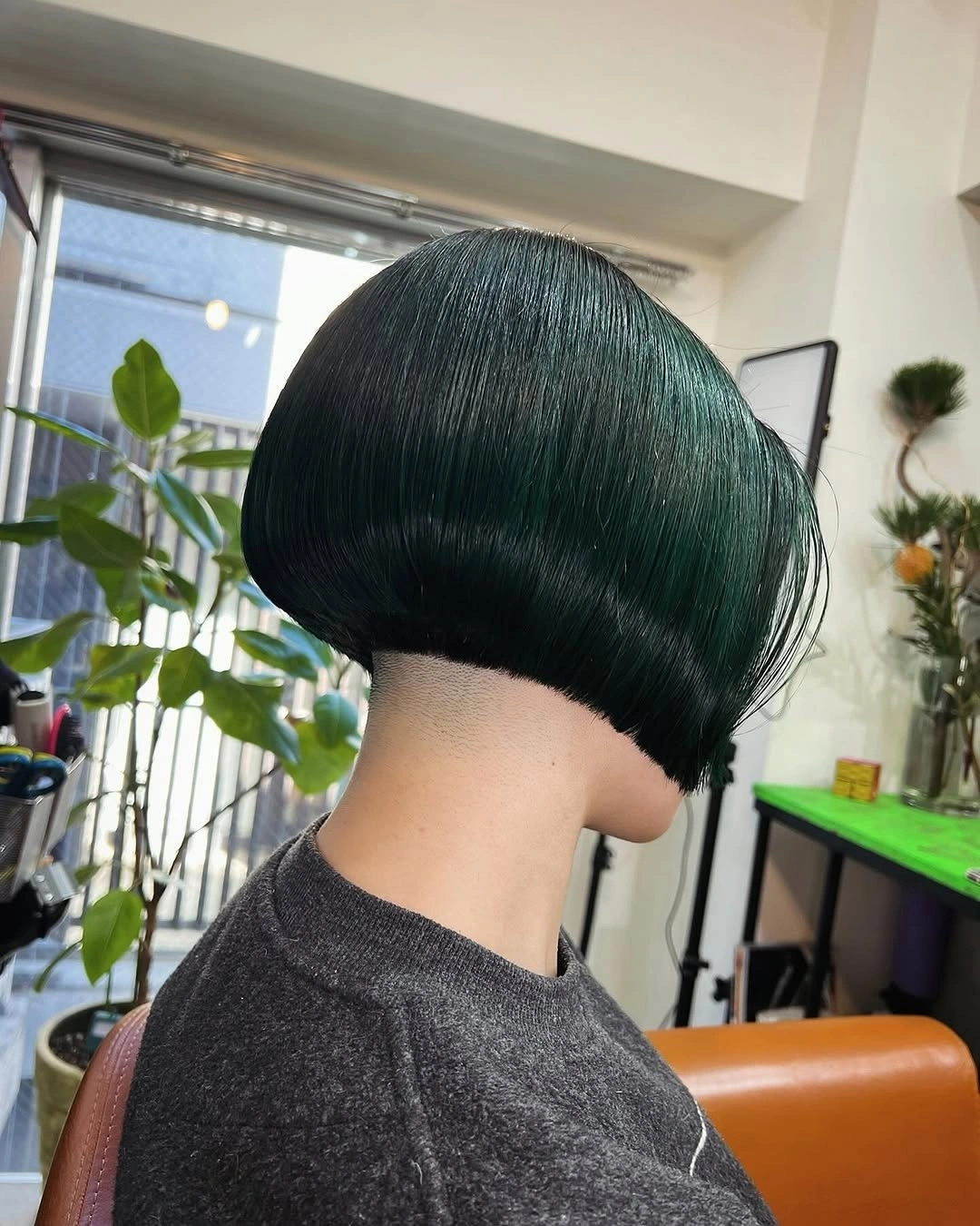 Rounded short deep green bob shown from the back