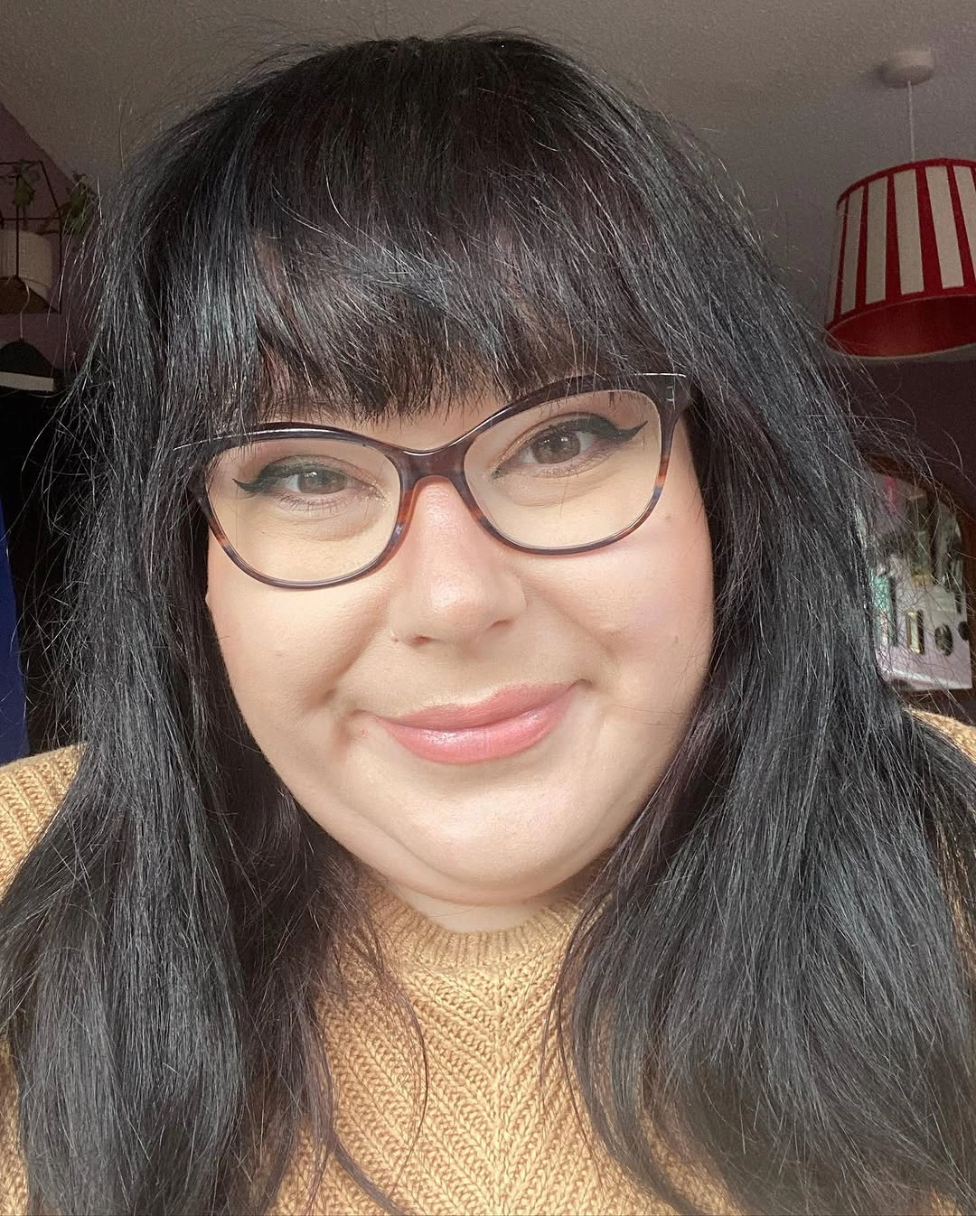 Long dark hair with full bangs and glasses