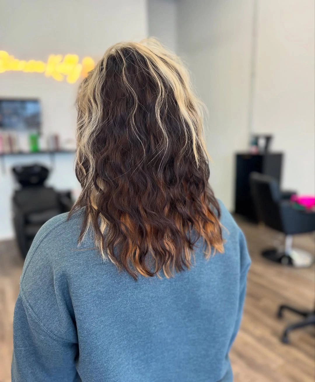 Long wavy hair with blonde side panel and warm ends