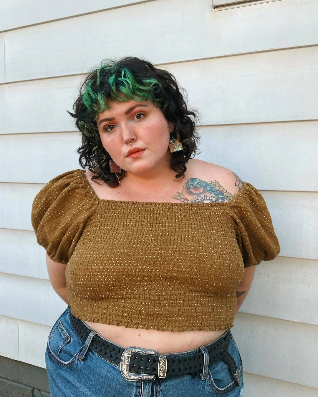 Short curly layered cut with green pieces and bangs