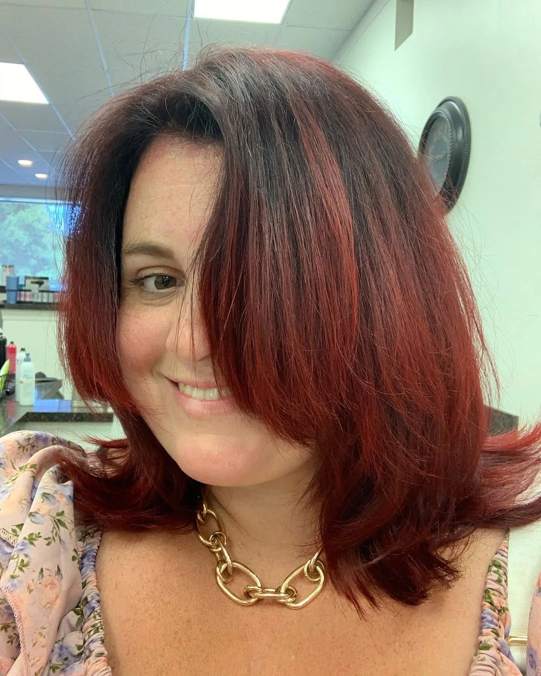 Red long bob with side-swept front and flipped ends