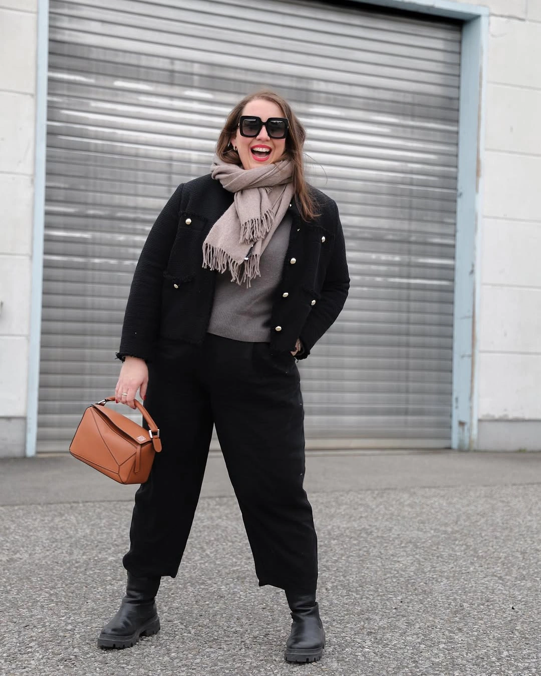 Black jacket with gray scarf, cropped trousers and boots