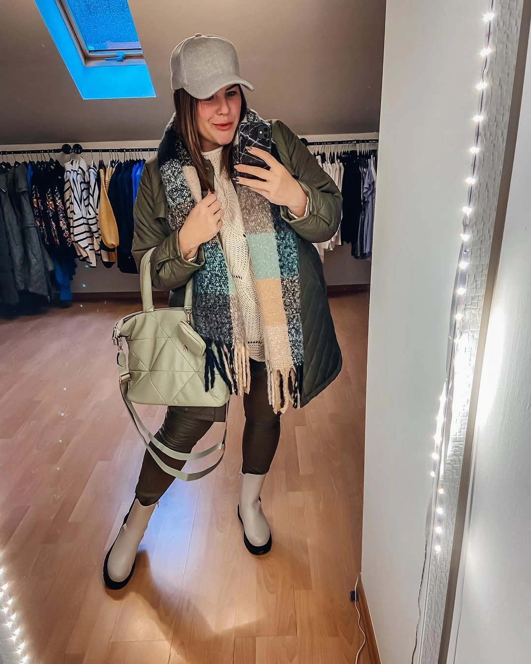 Green quilted outer layer with patterned scarf and white boots
