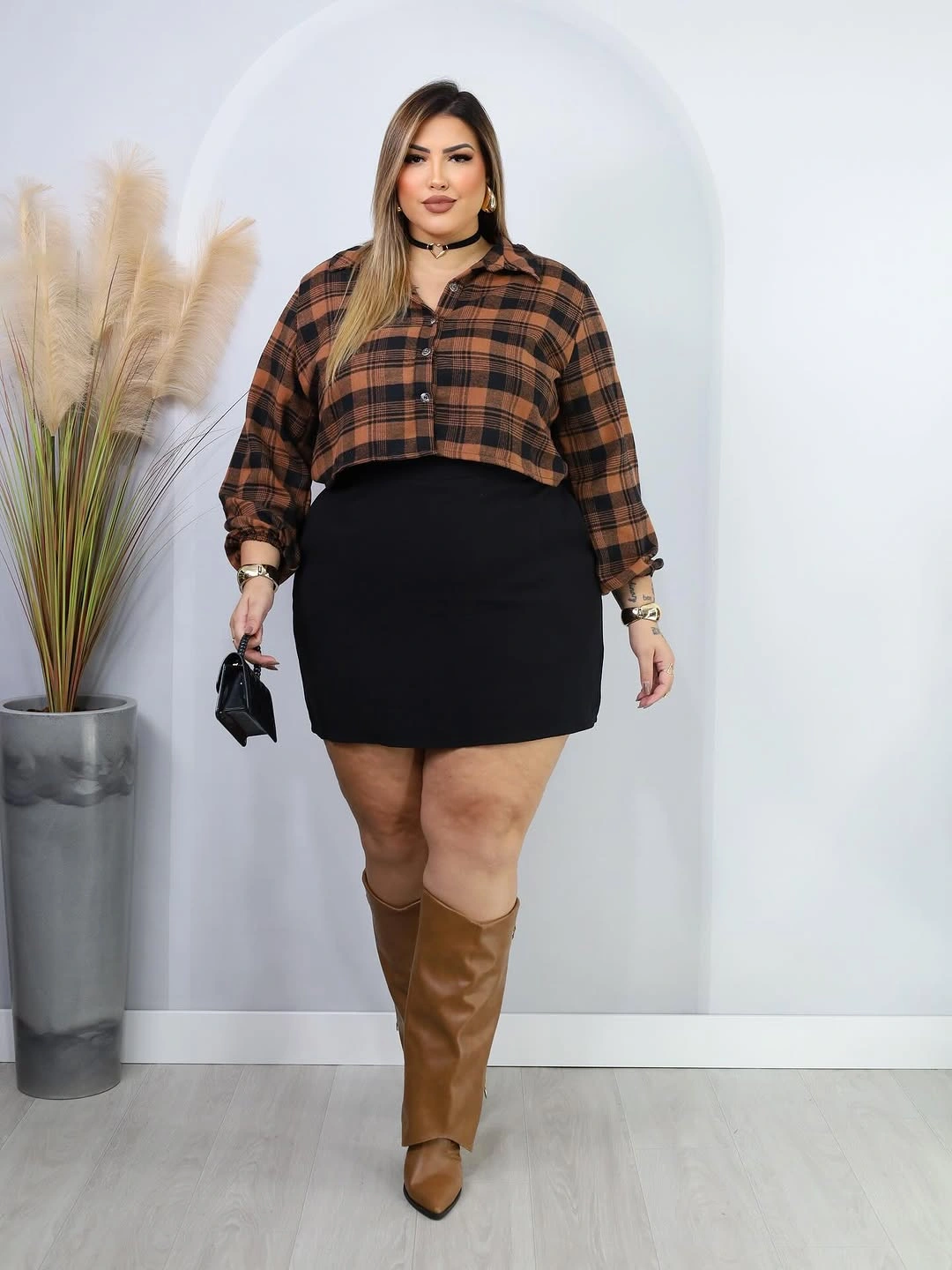 Cropped brown plaid top with black skirt and tan boots