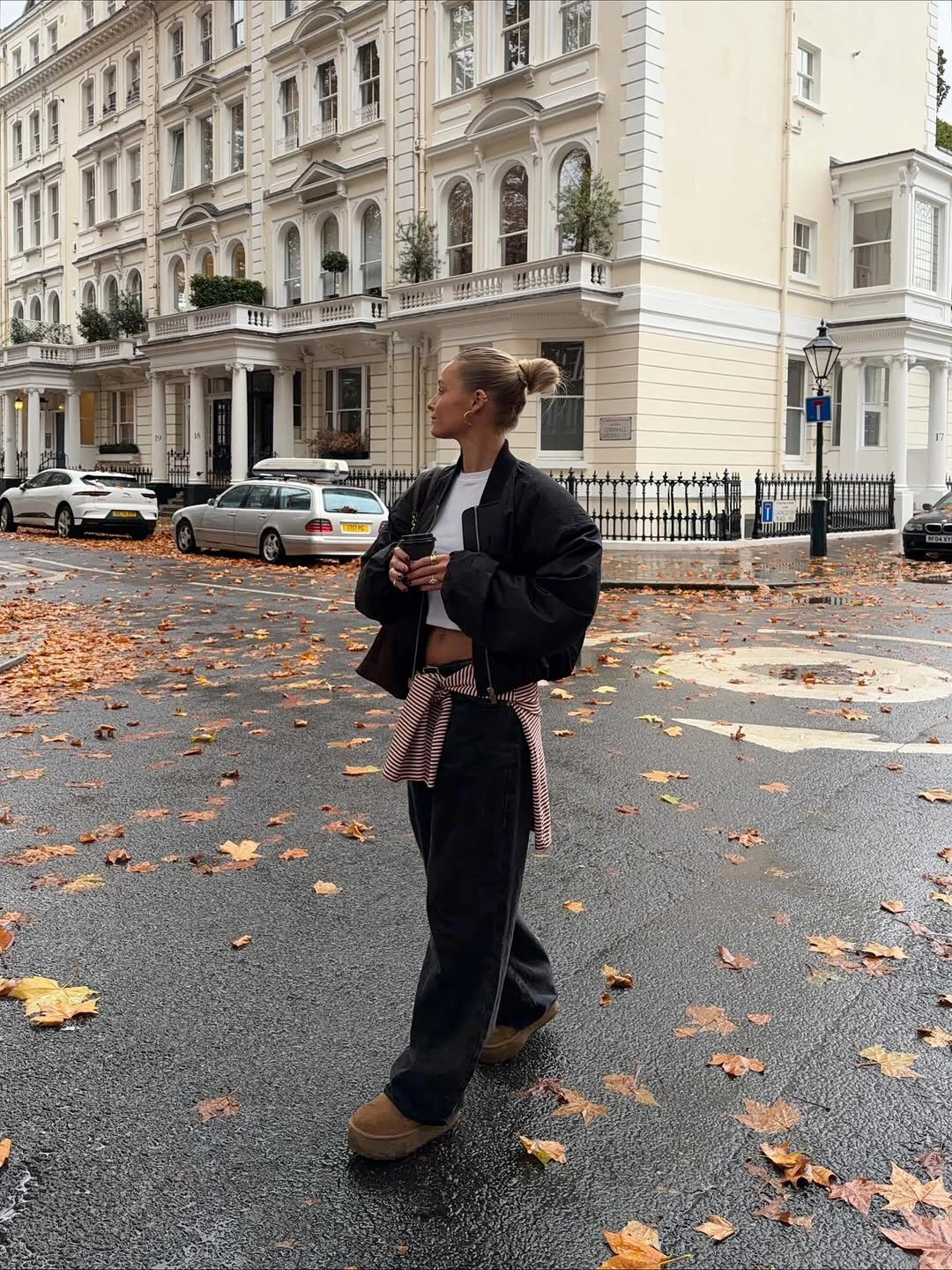 Black cropped jacket and trousers with checked shirt tied at waist