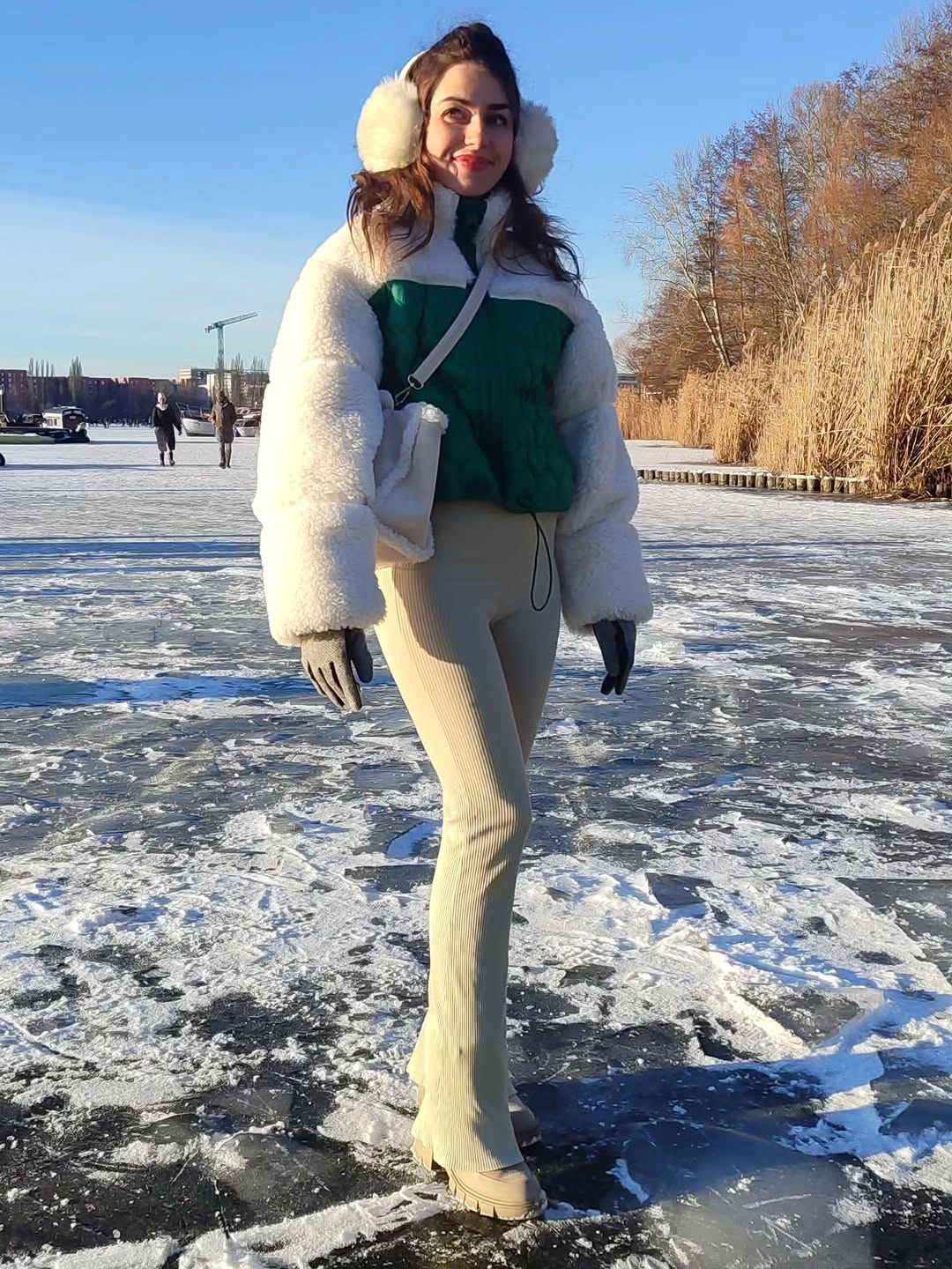 White fuzzy outer layer with green top and pale flared pants