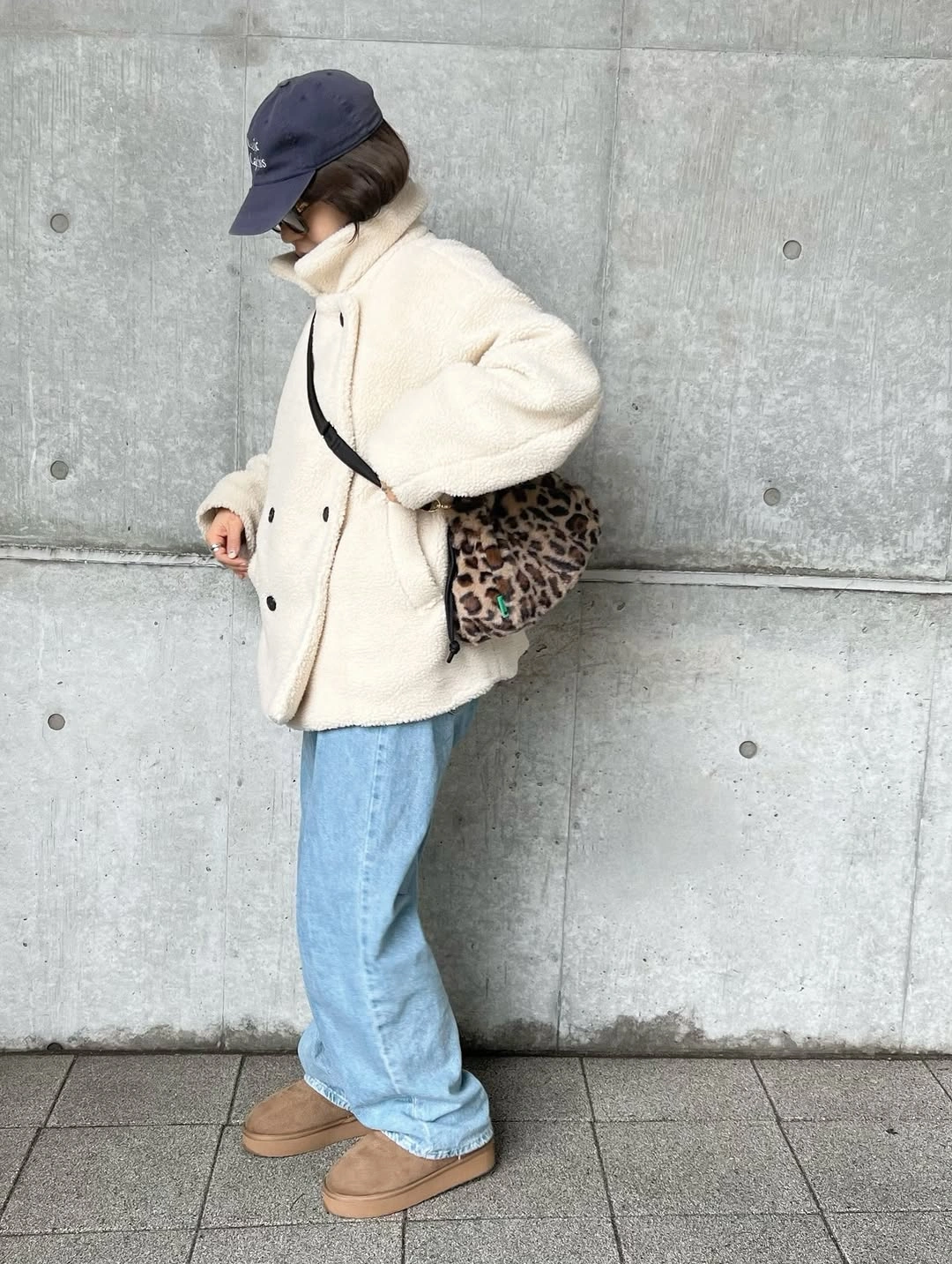 Cream fuzzy jacket with light jeans and leopard-print bag
