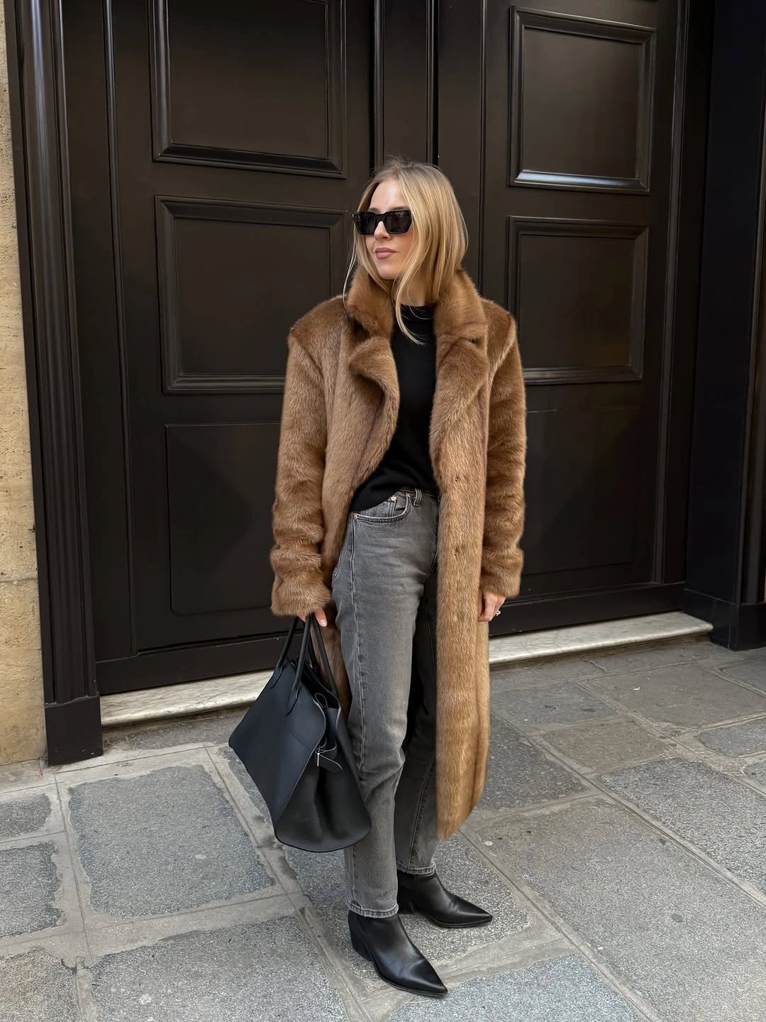 Long brown textured coat with gray jeans and black boots