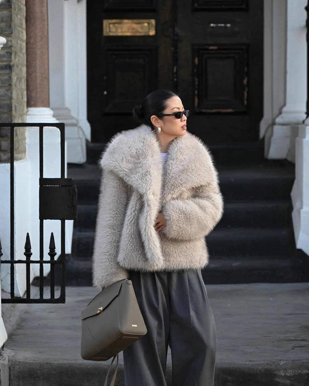 Pale gray textured coat with charcoal wide-leg trousers and taupe shoulder bag