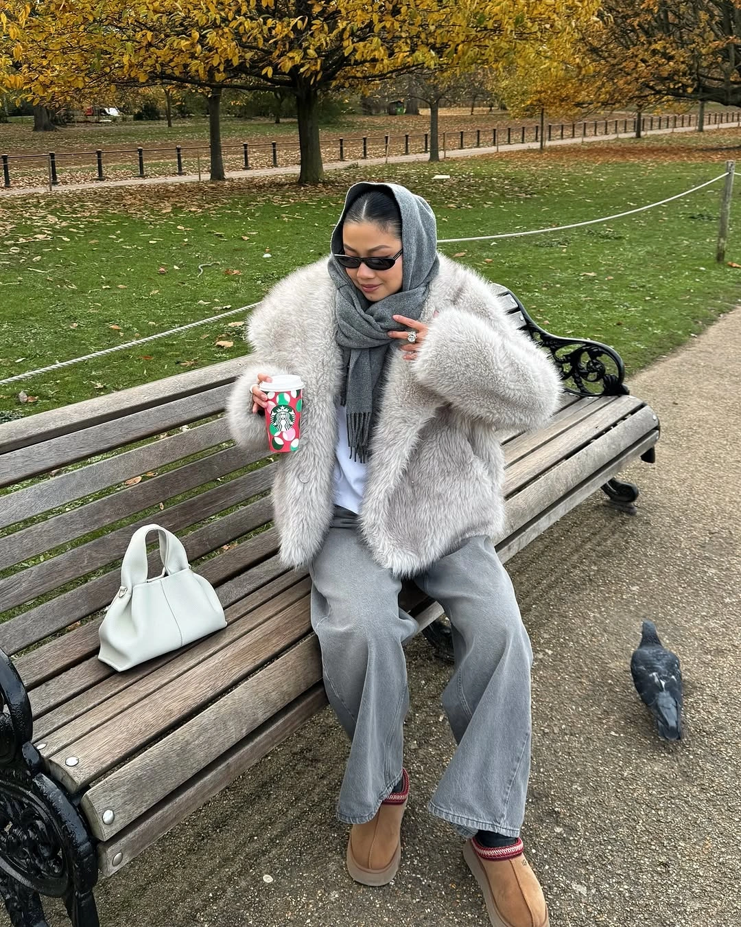 Pale gray plush coat with gray scarf, loose trousers, white top, and white handbag
