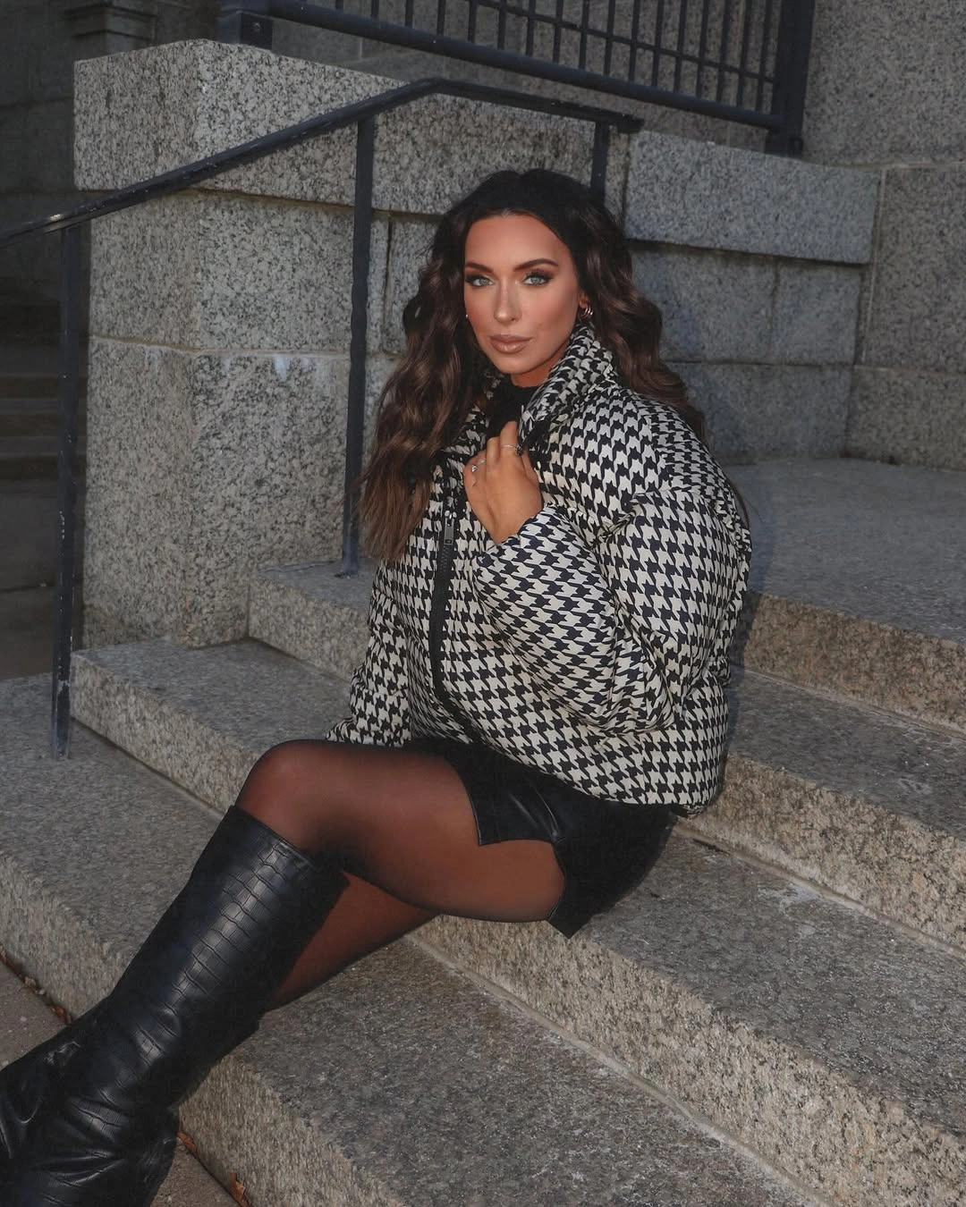 Black and white houndstooth jacket with black skirt, tights, and knee-high boots