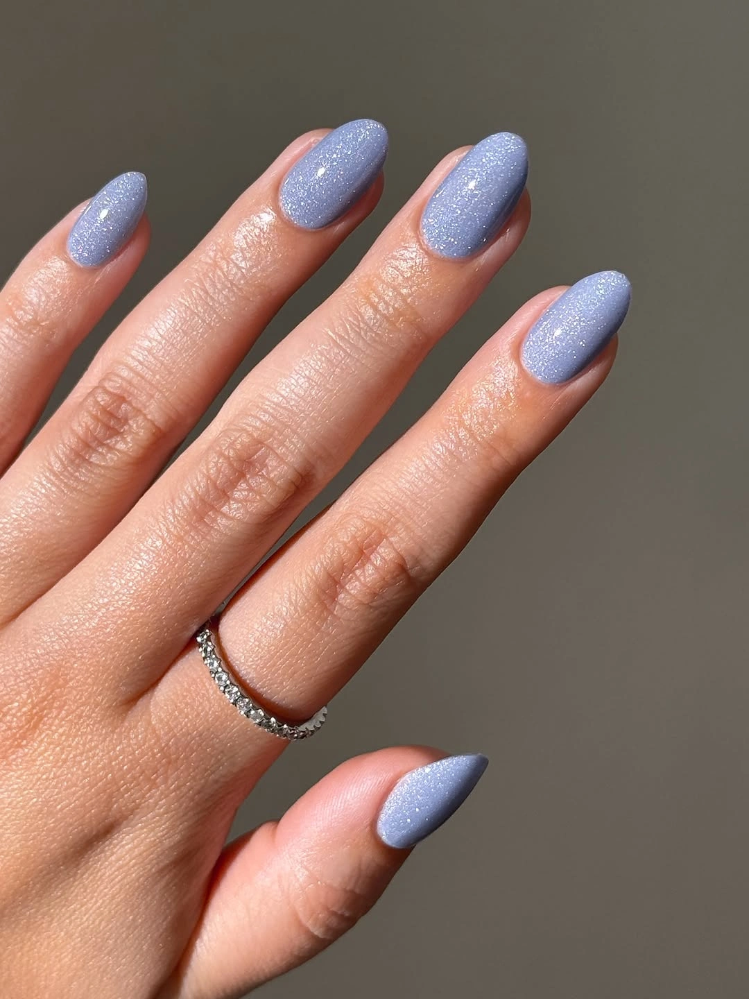 Pale periwinkle almond nails with fine shimmer finish