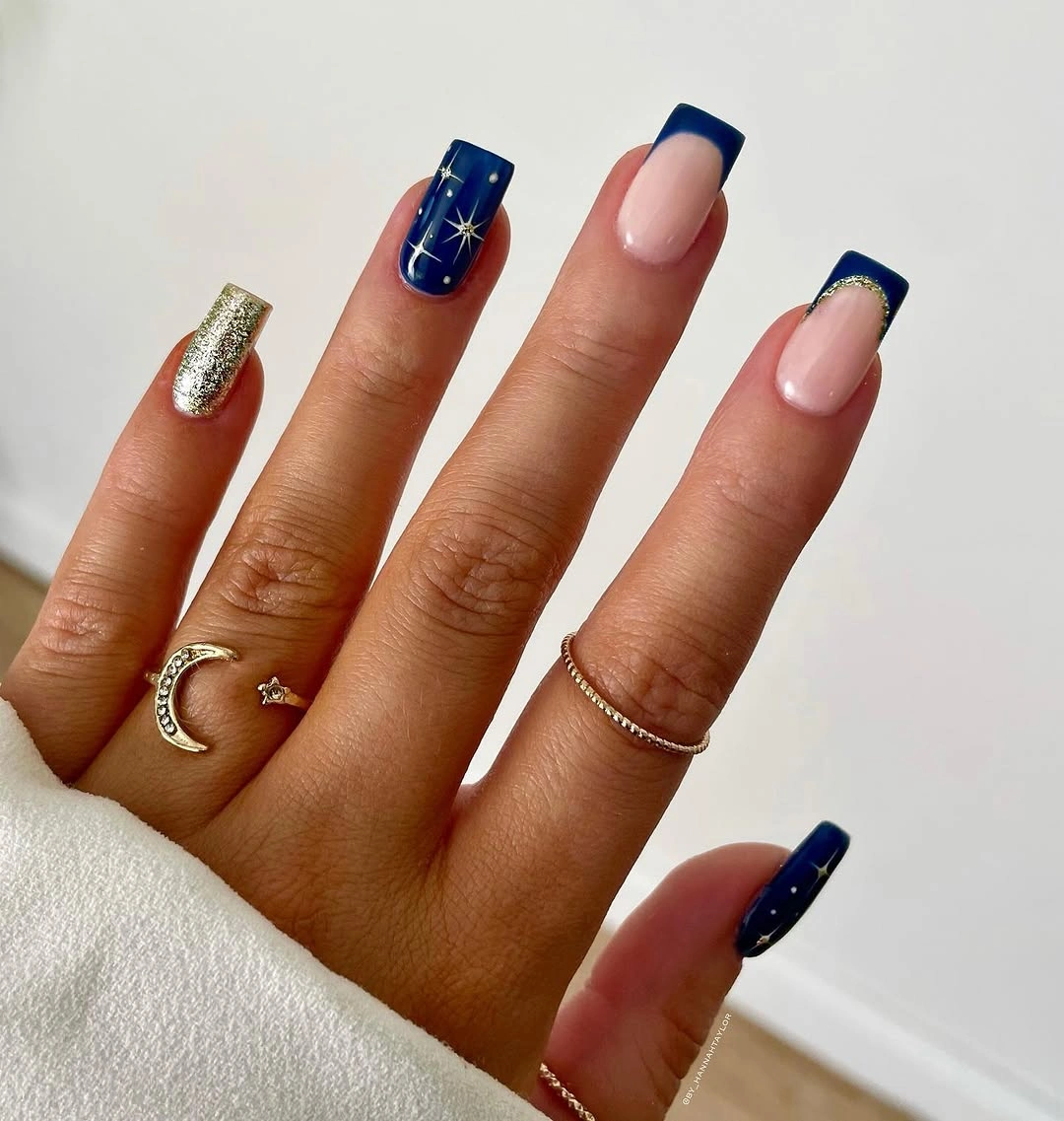 Square nails with navy tips gold glitter and stars