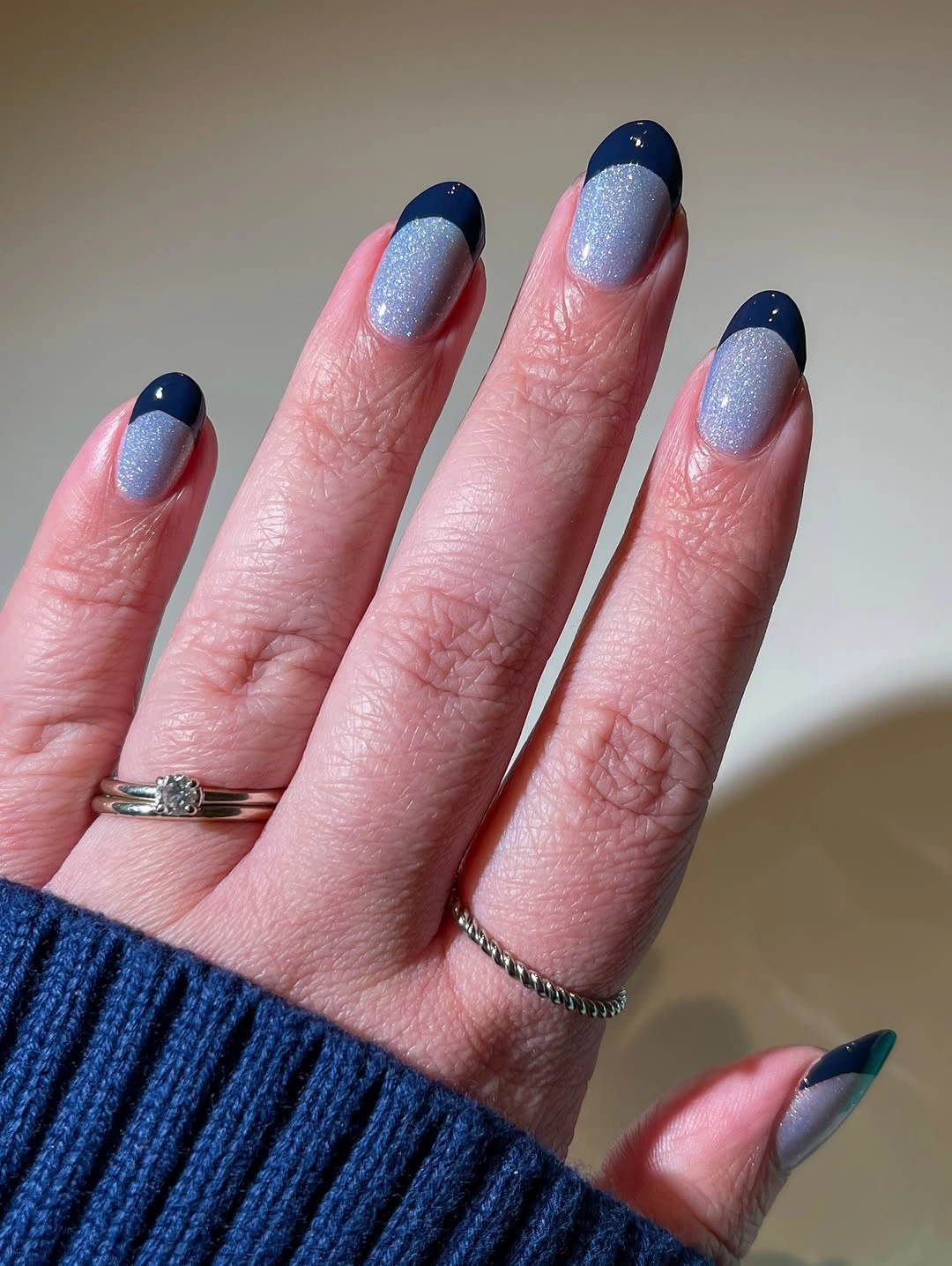 Icy blue shimmer nails with dark navy French tips