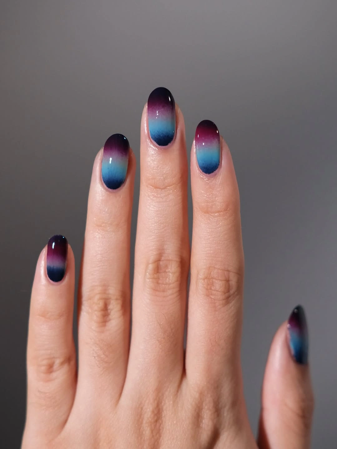 Short oval nails with navy teal and plum gradient