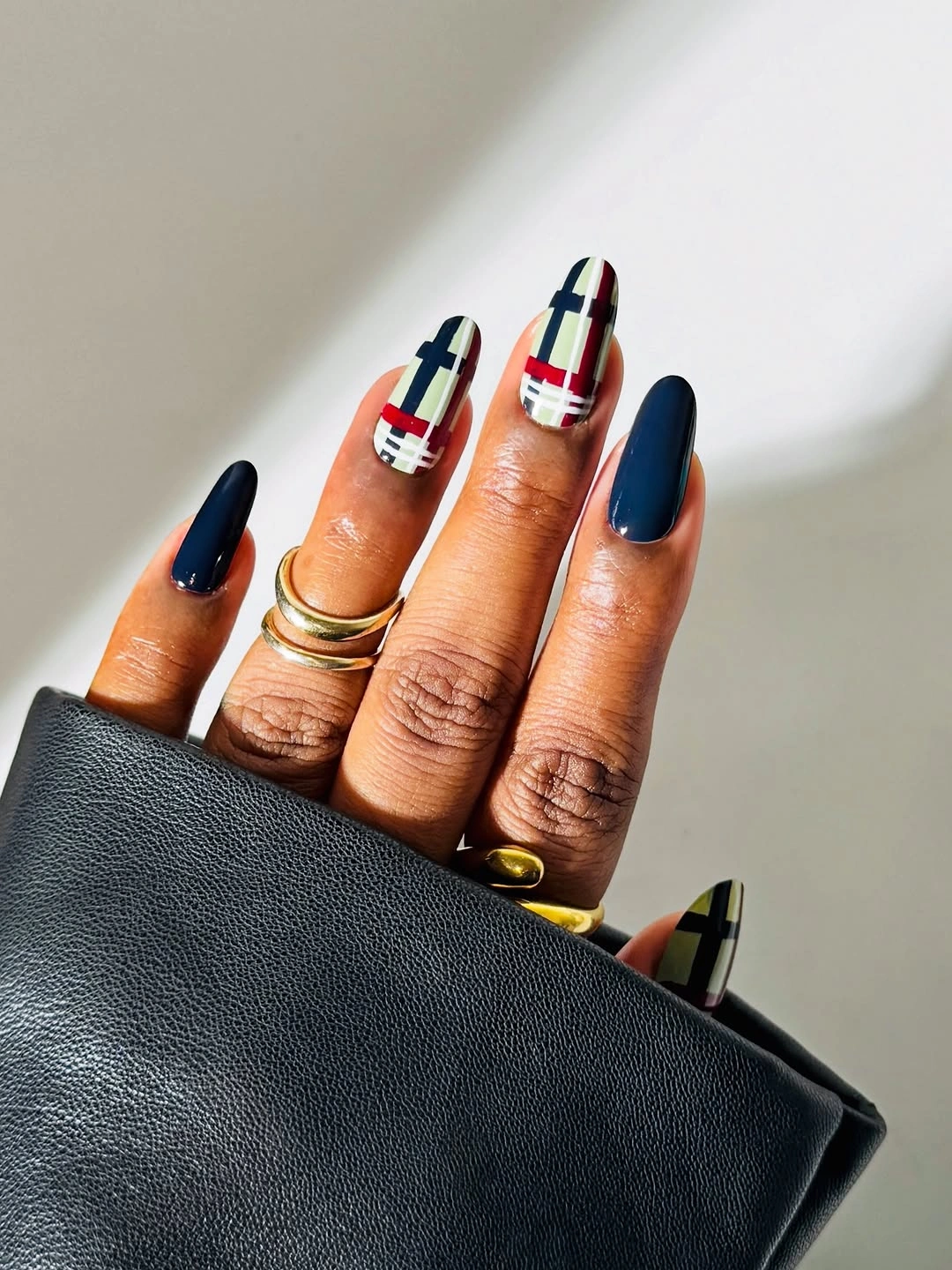 Dark navy almond nails with cream plaid accent nails