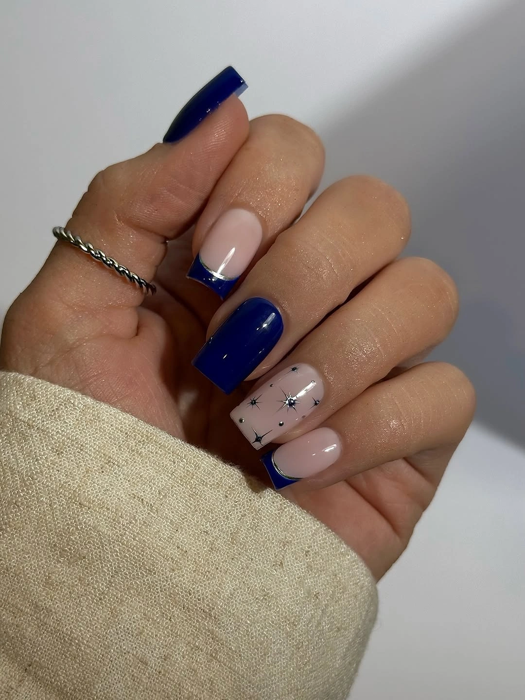 Royal blue square nails with nude tips and star accent